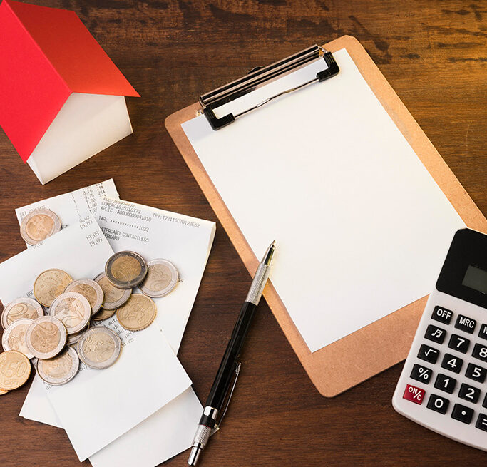 Tax paperwork and household budget items on a table