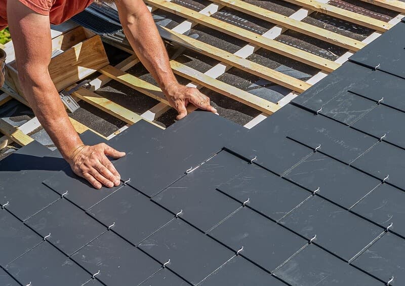 A Lakeland professional roofer installing roof tiles
