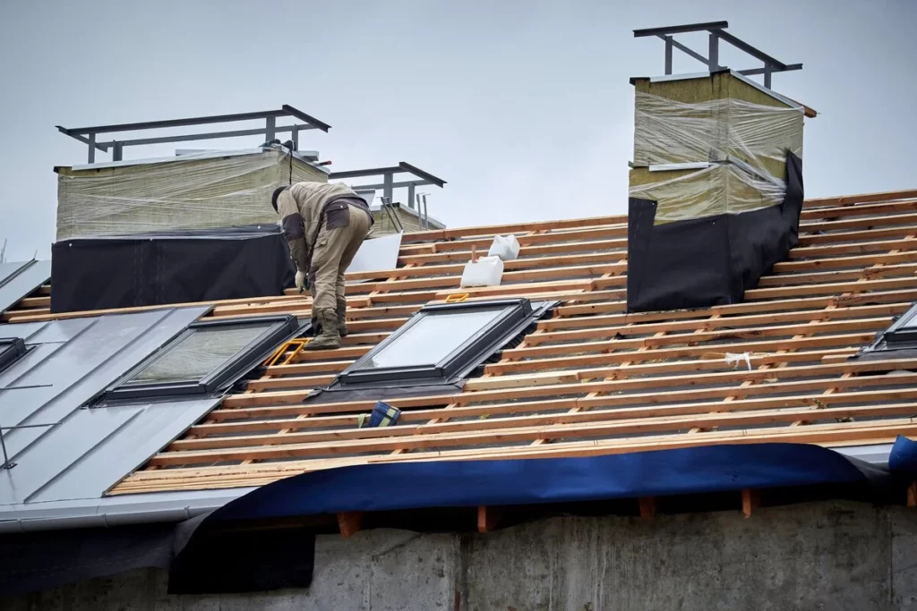 A roofer installing a sky light in Lakeland, FL