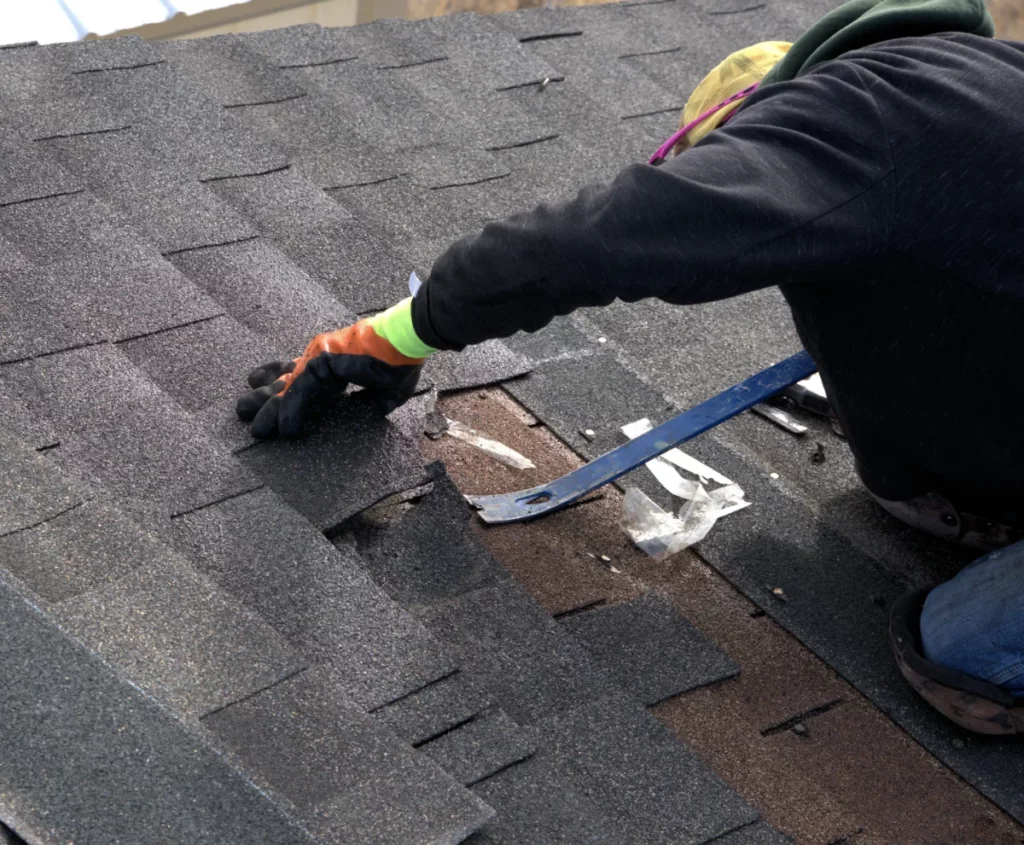 a roofer removing old roof to install new roof in Florida