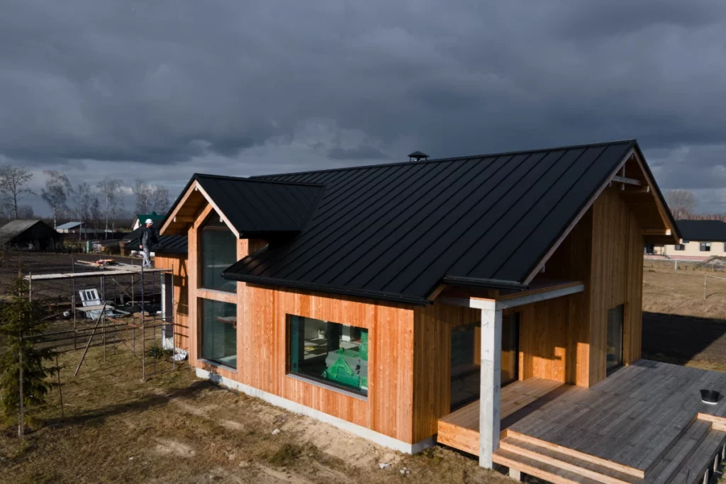 Beautiful wooden house with big windows and gable roofs