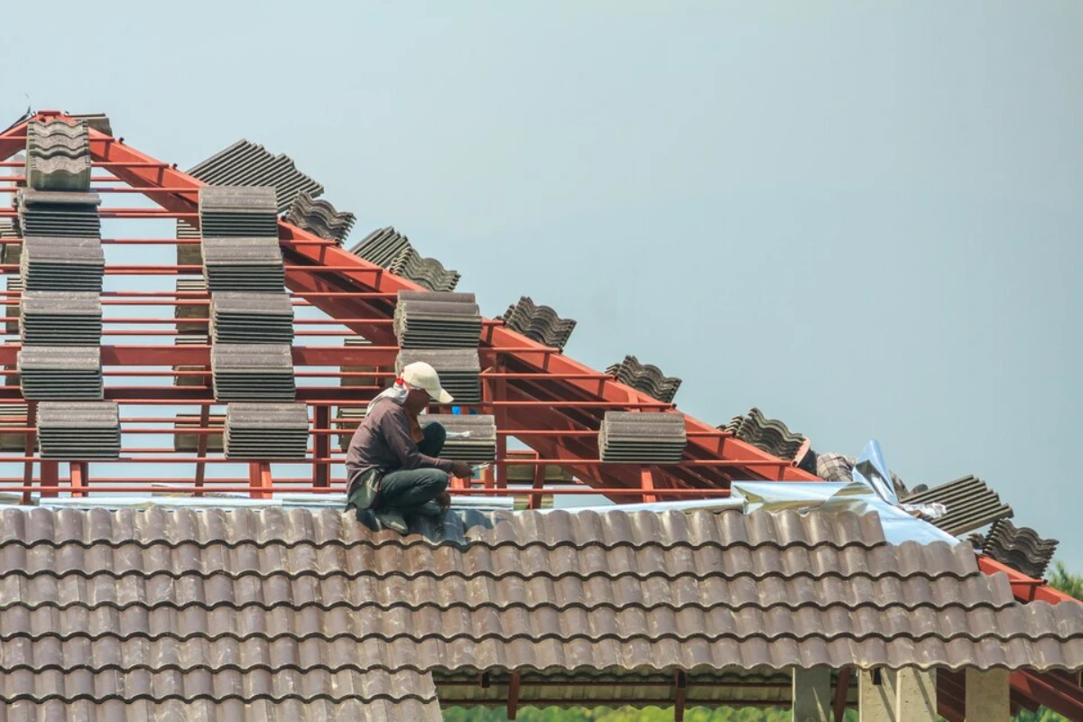 Worker installing roof tiles
